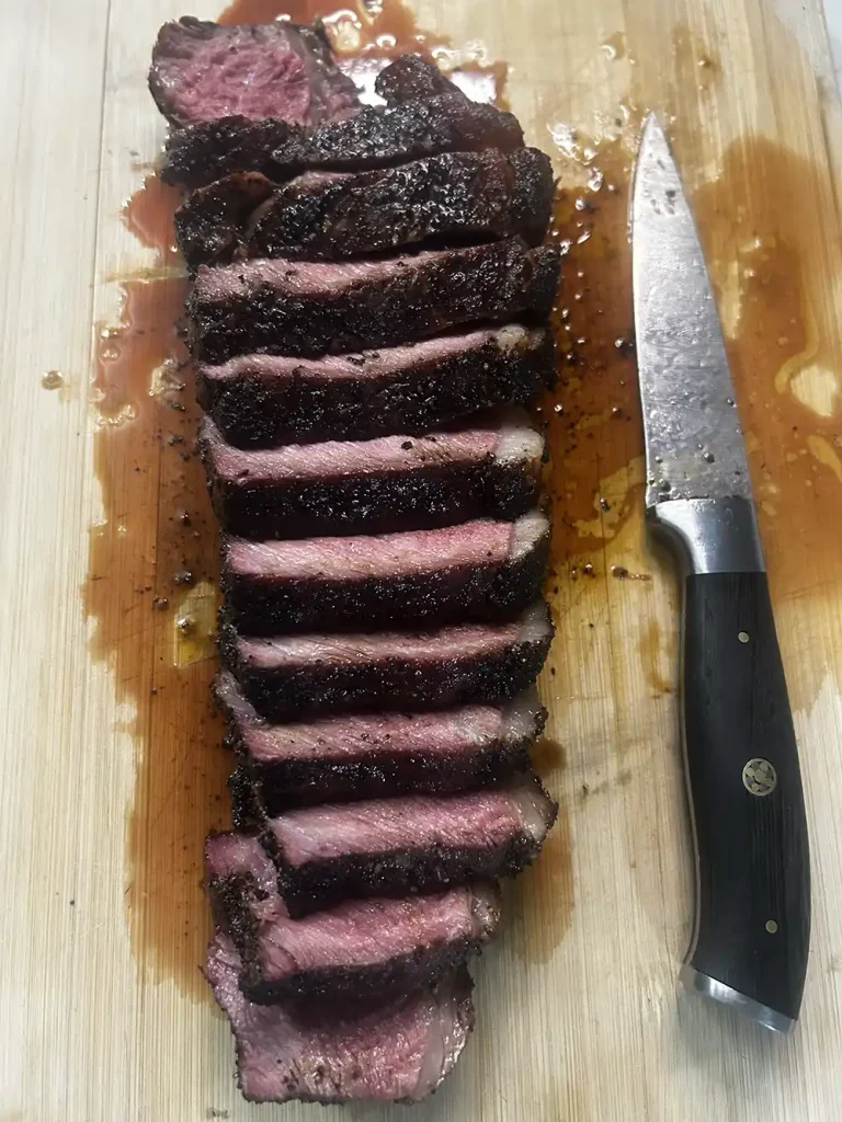 Reverse Sear NY Strip Steak sliced with knife